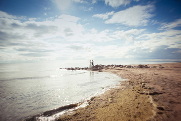 Fototapeta premium Figures of the bride and groom surrounded by a sea landscape
