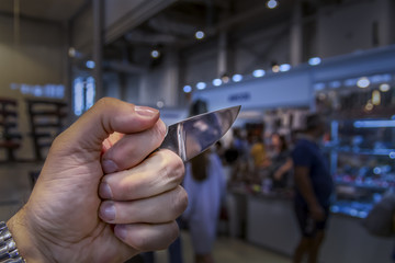 Brass knuckles with blade in fist. Copy space