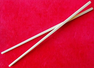 Chinese Sticks Chopsticks For Asian Food Eating On The Red Textile Velvet Cloth Background 