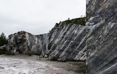 gray natural marble with white streaks in the canyon, deposit, Karelia.