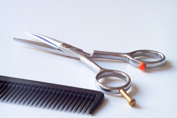 Hair cutting shears and comb isolated on white