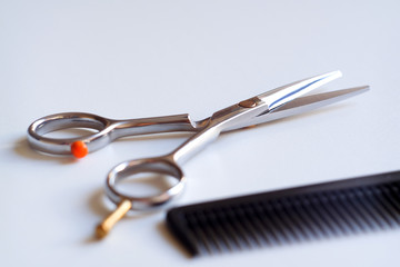 Hair cutting shears and comb isolated on white