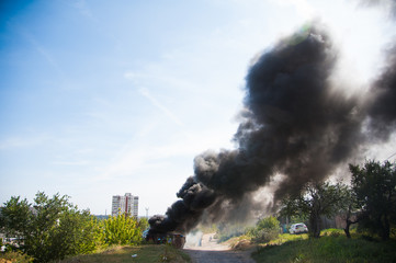 Fototapeta na wymiar Fire in the field near the city.