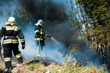 Firefighter extinguishes a fire