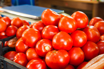 Fresh ripe tomatoes in a box for sale in the grocery shop