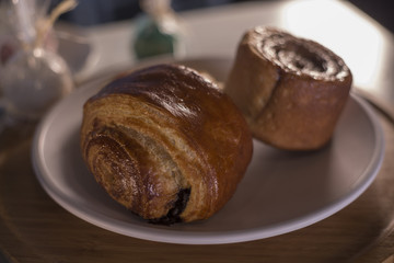 croissant with chocolate and coffee on wooden table