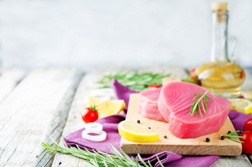 Tuna steak raw with lemon, rosemary, tomatoes and pepper