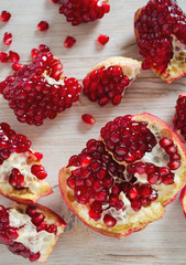 pomegranate seeds on wooden surface