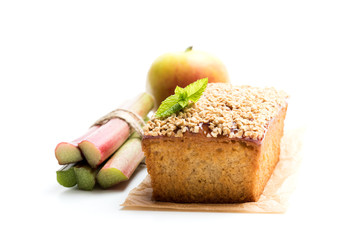 Homemade  apple and cinnamon cake topped with rhubarb jam and sweetened oats isolated on white
