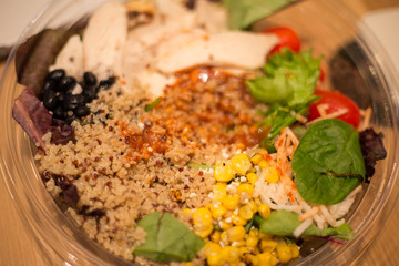 Chicken Salad with spinach, Cherry tomatoes, corn salad, baby spinach, fresh mint and basil. Home made food. Concept for a tasty and healthy meal. Dark stone background. Top view. Close up.