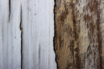 old white flaky peeling paint on a wooden window frame, macro