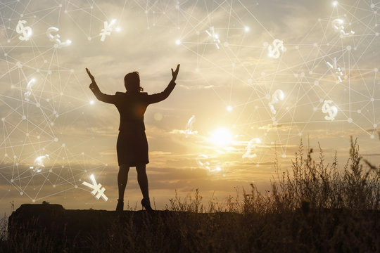 Businesswoman with arms raised from a successful operation .