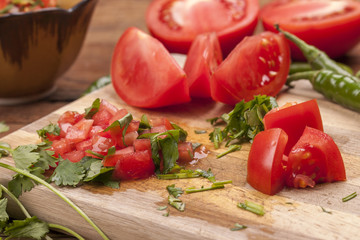 Close up of tomatoes and cilantro for salsa.
