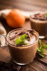 chocolate mousse dessert with orange on rustic wooden background.
