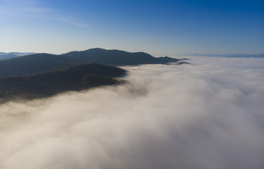 aerial view of mountain above clouds. Romania