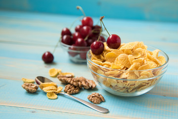 Tasty cornflakes with walnut in glass bowl