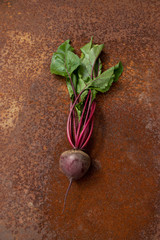 Raw beetroots from new harvest on rusty melallic surface background
