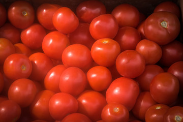 Red tomatoes background at open  market .