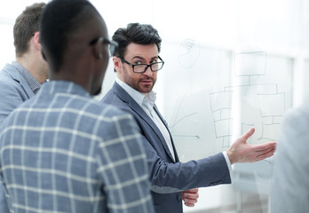 businessman explains something to his business partners