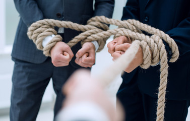 close up.businessman pulls a business team on a rope