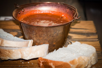 Traditional appetizing  hungarian goulash soup in cauldron .