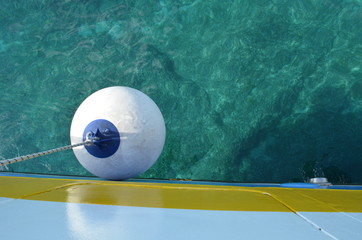 buoy of a small boat in the blue and cyan colored water