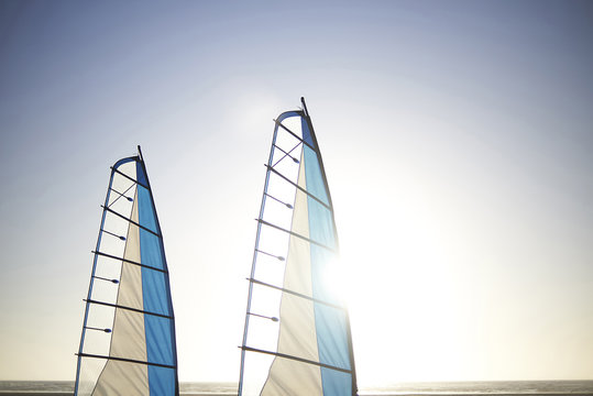 Sailboats in sea against clear sky