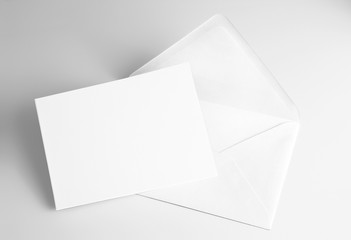 Blank folded white card and envelope  - obrazy, fototapety, plakaty