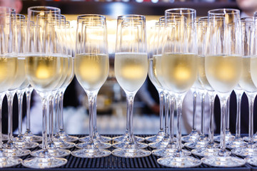 Many glasses of champagne in a line. Selective focus. Vintage tone