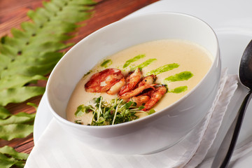 Creamy cheese soup with grilled shrimps