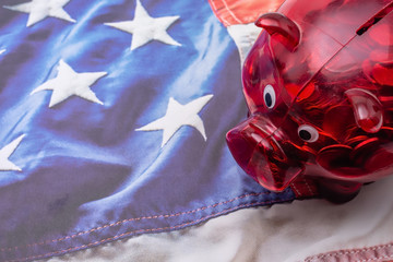 Red piggy bank on American flag background with room for copy text