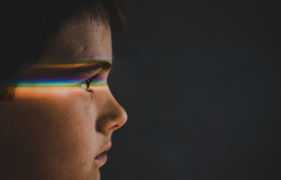 Close up of thoughtful boy with spectrum on eyes