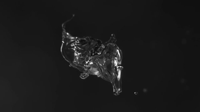rain drops of clear water colliding in slow motion forming beautiful detailed splash uniting in a single huge drop, 4k, super macro shot, black-white