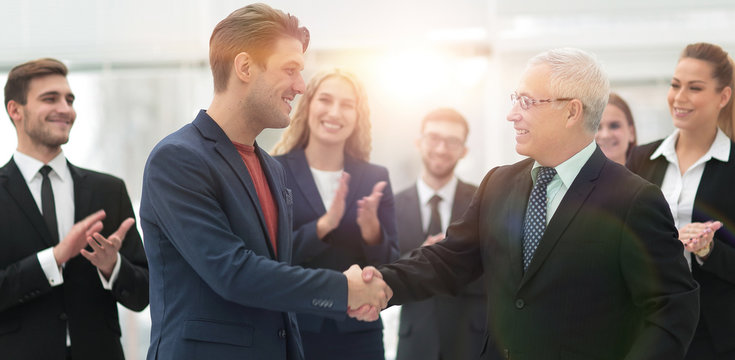 handshake of business partners after a business meeting in the office