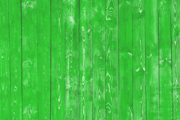 Light green old wooden background of boards. Old, worn, cracked paint. Bright saturated color.