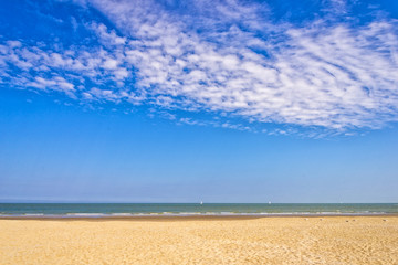 Summer beach, sea and vibrant sky with clouds
