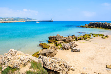 Fototapeta na wymiar Rocks on sea coast and view of beach in Tarifa town, Costa de la Luz, Spain
