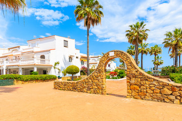 Gate to park and white houses with tropical plants in small coastal village near Marbella, Costa del Sol, Spain © pkazmierczak