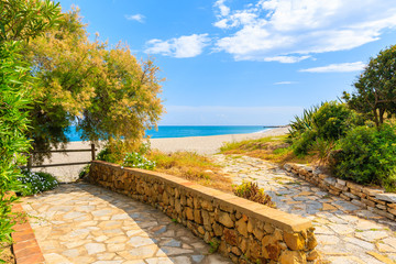Path to beautiful beach with tropical plants in small coastal village near Marbella on Costa de Sol, Spain © pkazmierczak