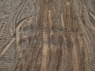Many different wheel tracks on sand