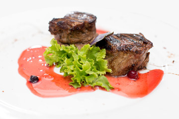 grilled beef steaks with spices isolated on white background