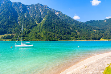 Boat on water of beautiful Achensee lake on sunny summer day, Tirol, Austria