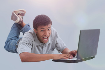 Happy african man with a laptop - isolated over white