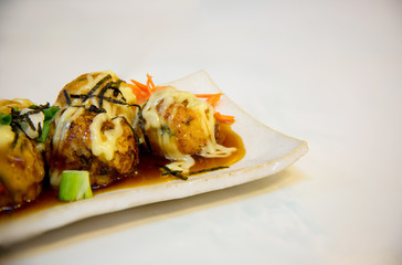 Japanese food Tako Yaki on white plate.Takoyaki fried battered squid balls traditional japanese cuisine.Tako-yaki  octopus balls dumpling.
