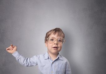 Adorable little boy portrait with empty grey wall background