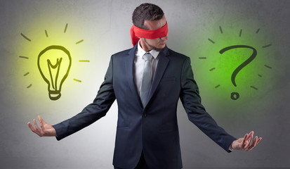 Covered eye businessman with bulb and question sign symbols around