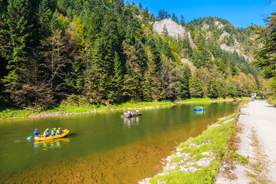 Rafts with tourist on Dunajec river in autumn landscape of Pieniny Mountains, Poland