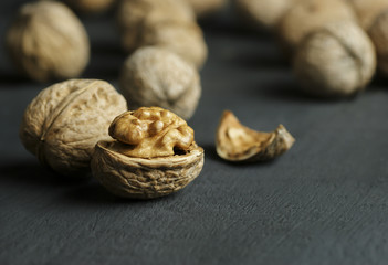 walnut kernel with shell on wooden backdrop. healthy food for brain. walnut background 