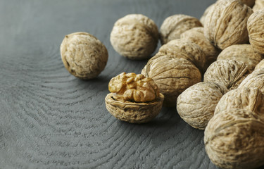 walnut kernel with shell on wooden backdrop. healthy food for brain. walnut background 