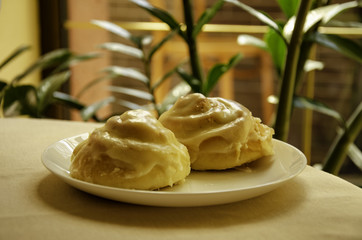 Two rolls, a cake on a coffee table in a cafe.